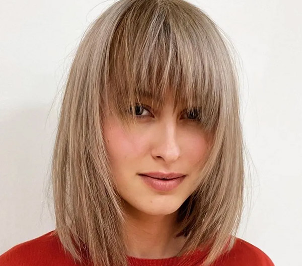 49. Medium-Length Layered Hair with Side Bangs